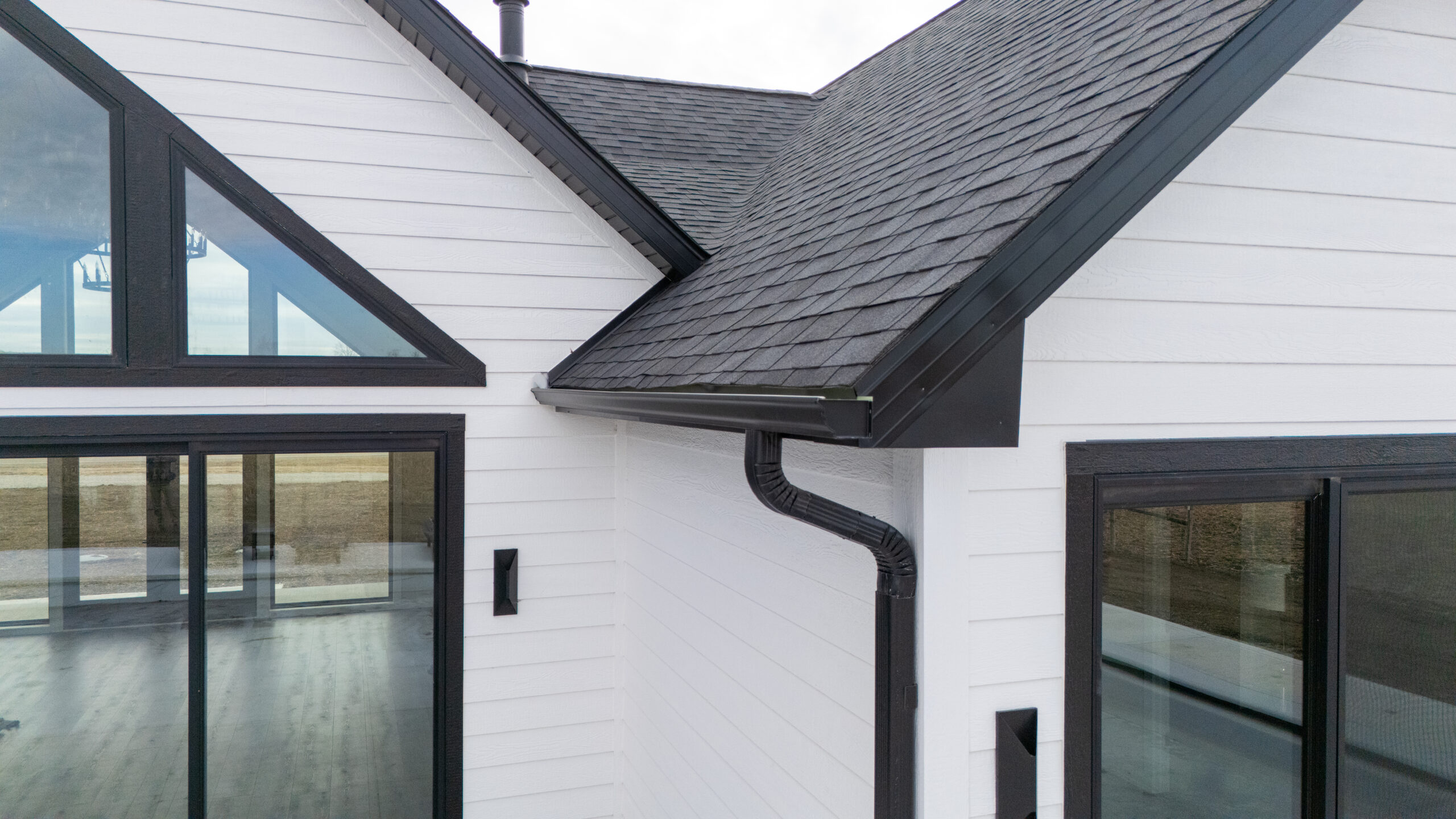 Modern seamless copper gutters installed on a traditional brick house